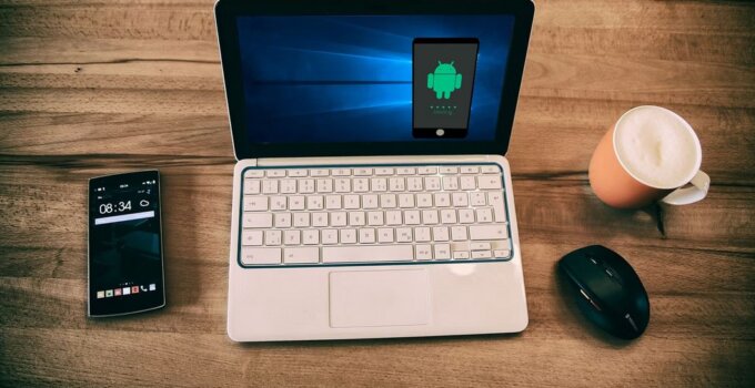 iOS emulator with laptop and iphone on a coffee table
