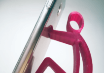red 3D mobile phone holder is holding a smartphone