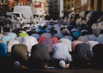 people kneeling and praying during daytime