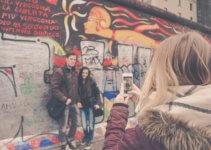 woman taking photo of couple