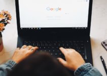 person using black laptop computer to install Google Chrome SEO extensions