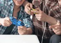 3 men playing games in their gaming room