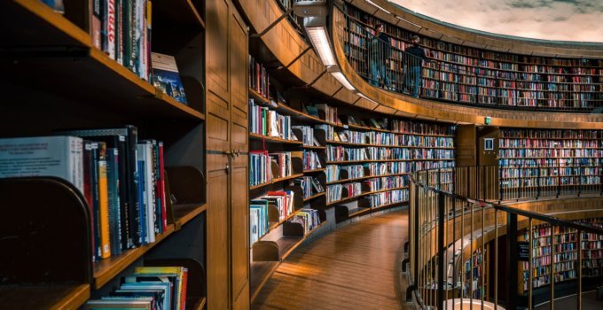Brown wooden book shelves with books. AI-assisted education is the future of learning.