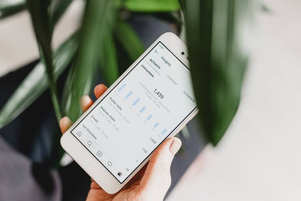 View your Instagram insights Person using smartphone to see who views your Instagram profile.