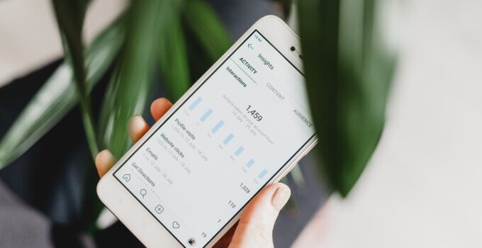 Person using smartphone to check their Instagram activity and insights