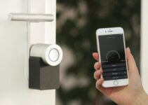 Apple iPhone smartphone held near a Nuki Smart Lock