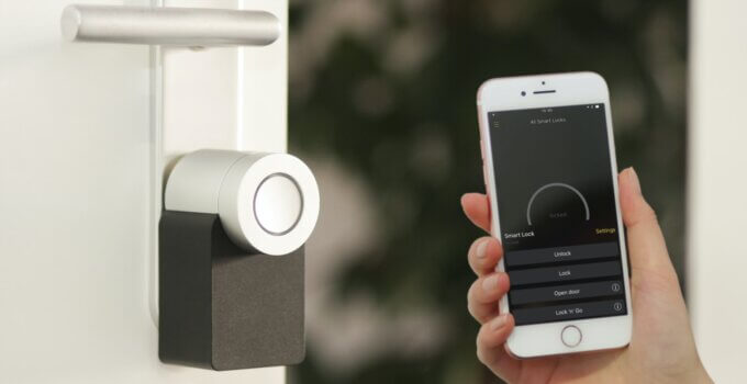 Apple iPhone smartphone held near a Nuki Smart Lock