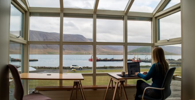 Productivity apps for students - person in blue jacket sitting on brown wooden chair near brown wooden table during daytime