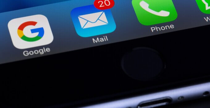 Image of a laptop screen showing the Gmail icon with 20 unread messages