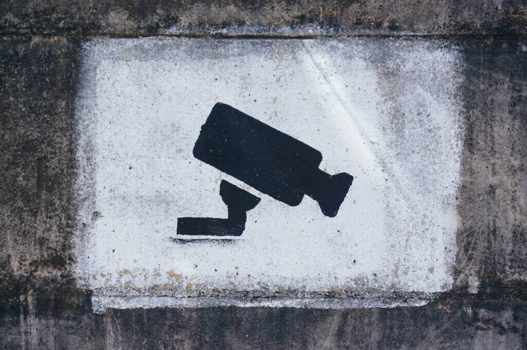 Sign with security camera black and white frame with security camera image