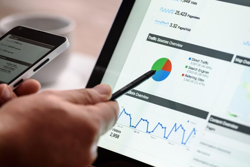 Person using a pen to point to a Google Analytics dashboard result