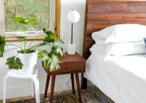 Modern rustic wooden bed frame white potted green plant on brown wooden table