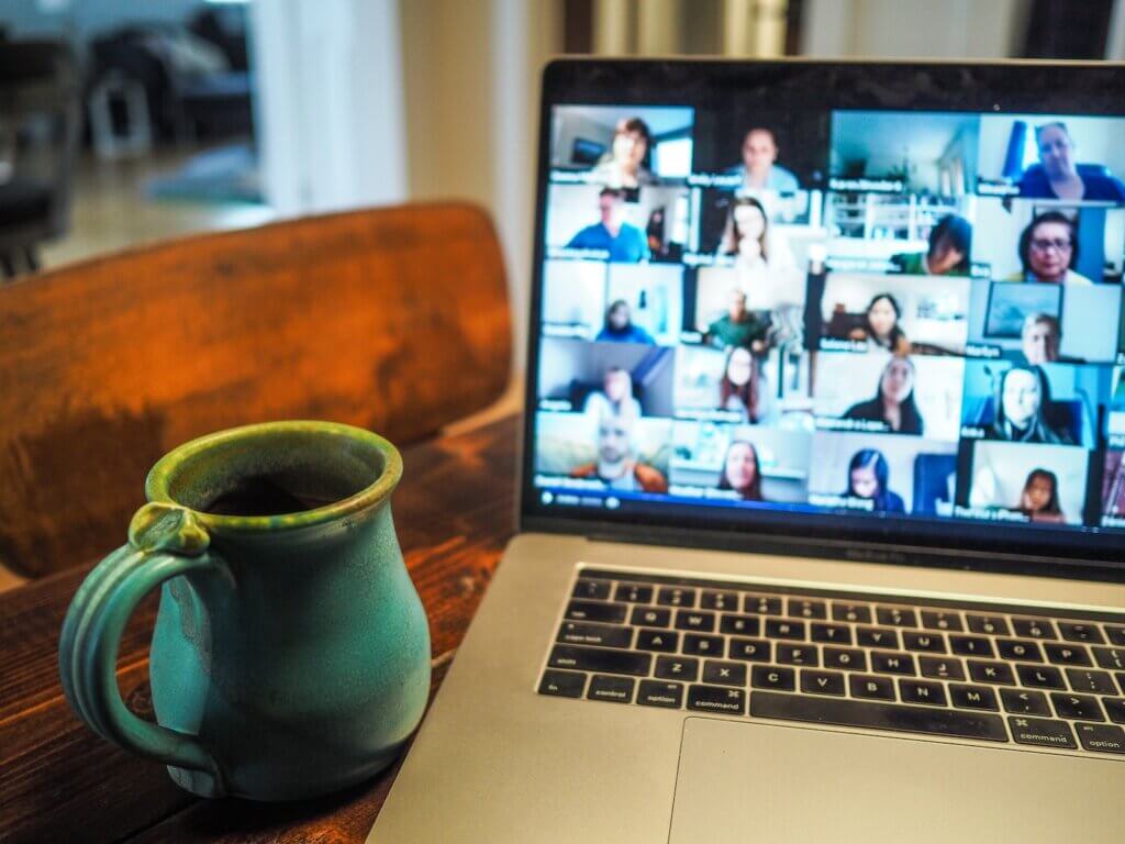 Laptop on desk with cup of tea using iMind online video conferencing