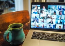 Laptop on desk with cup of tea using iMind online video conferencing