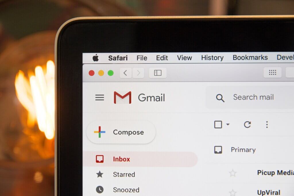 Black laptop computer with Gmail open in Safari browser using AImReply