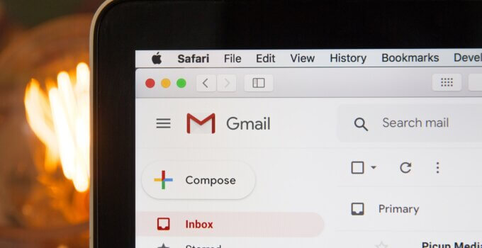 Black laptop computer with Gmail open in Safari browser using AImReply